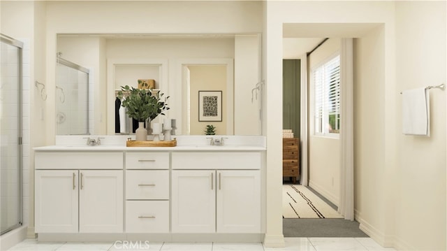 bathroom featuring a sink, double vanity, a stall shower, and baseboards