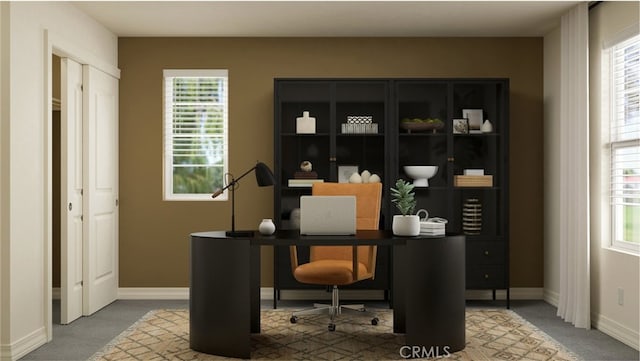 carpeted office space featuring baseboards