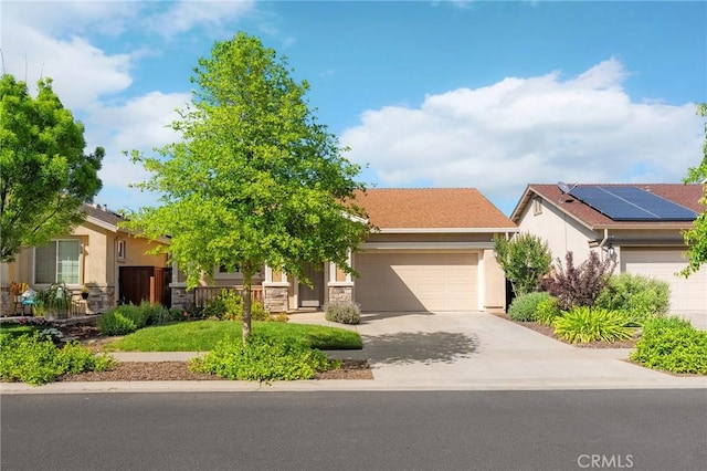 view of front facade featuring an attached garage, stucco siding, stone siding, and driveway