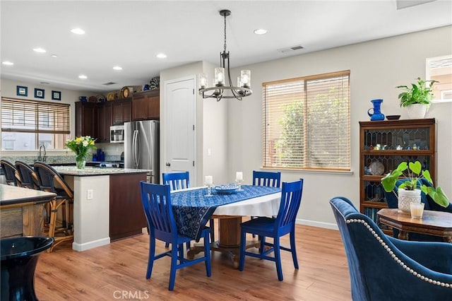 dining room with a chandelier, recessed lighting, visible vents, and light wood-style floors