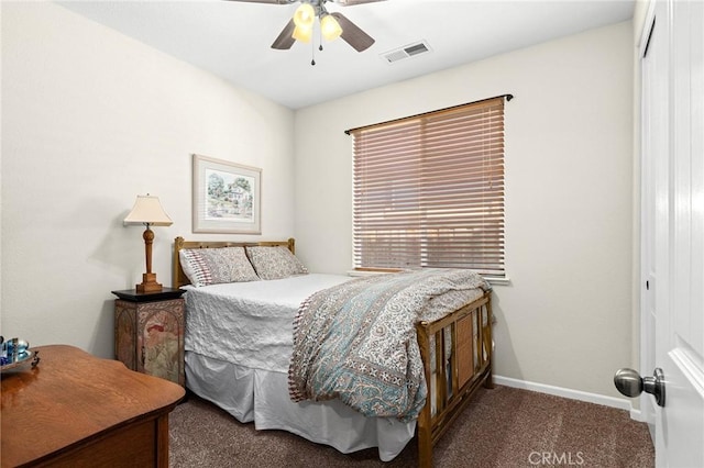 carpeted bedroom featuring baseboards, a closet, visible vents, and a ceiling fan