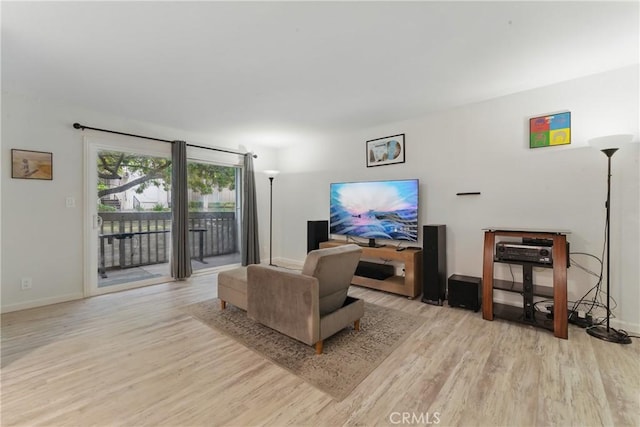 living area with wood finished floors and baseboards