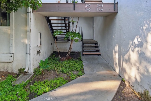 doorway to property featuring stucco siding