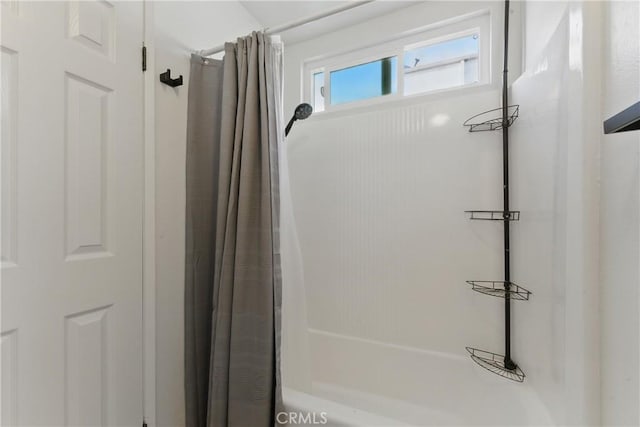 bathroom with shower / bath combo with shower curtain
