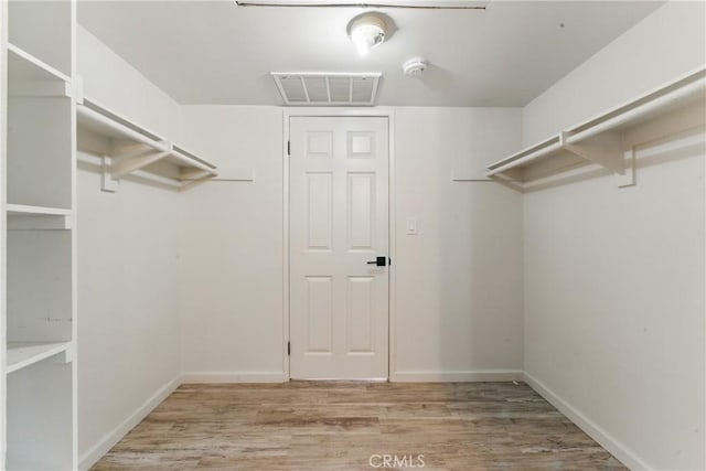spacious closet featuring light wood finished floors and visible vents