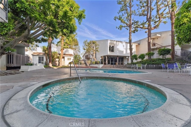 pool featuring a patio and fence