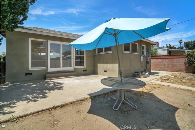 back of house with a patio area, fence, entry steps, and crawl space