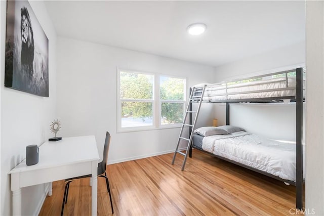 bedroom with baseboards and wood finished floors