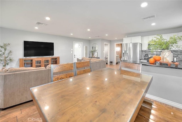 1261 W 13th St, San Bernardino, CA 92411 - dining space with light wood-type flooring, visible vents, and recessed lighting