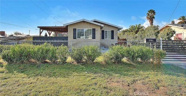 1261 W 13th St, San Bernardino, CA 92411 - view of front of house featuring stucco siding, fence, a front yard, and a carport