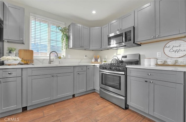 1261 W 13th St, San Bernardino, CA 92411 - kitchen featuring gray cabinetry, appliances with stainless steel finishes, and light countertops