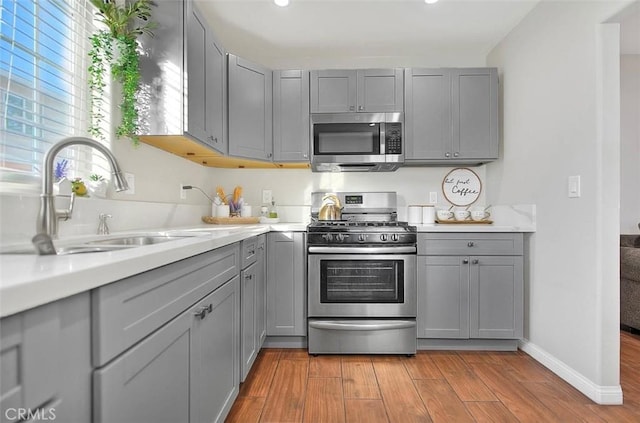 1261 W 13th St, San Bernardino, CA 92411 - kitchen with gray cabinetry, appliances with stainless steel finishes, and a sink