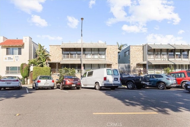 view of property with uncovered parking