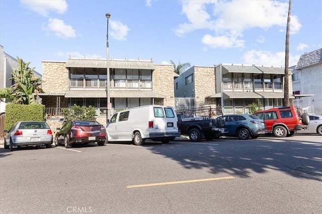 view of property featuring uncovered parking