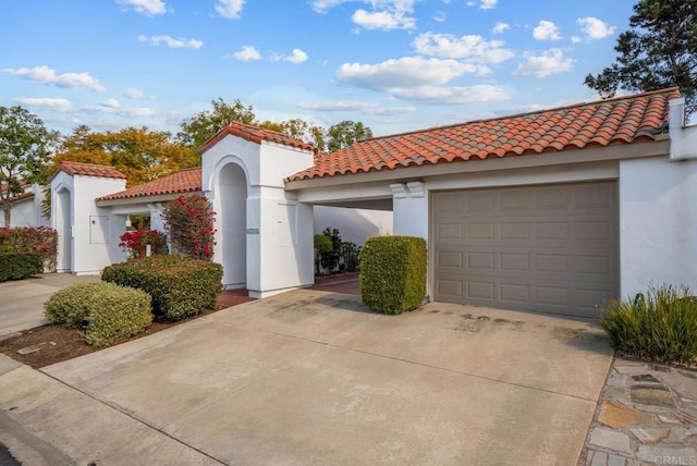 4704 Cordoba Way, Oceanside, CA 92056 - mediterranean / spanish house featuring an attached garage, stucco siding, a tiled roof, and driveway