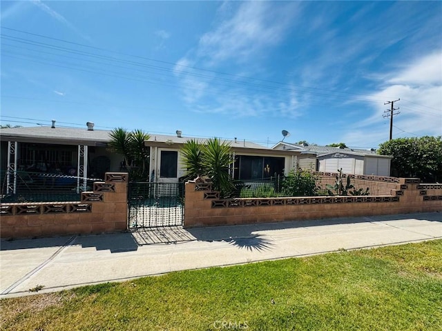 view of front facade with a fenced front yard and a gate