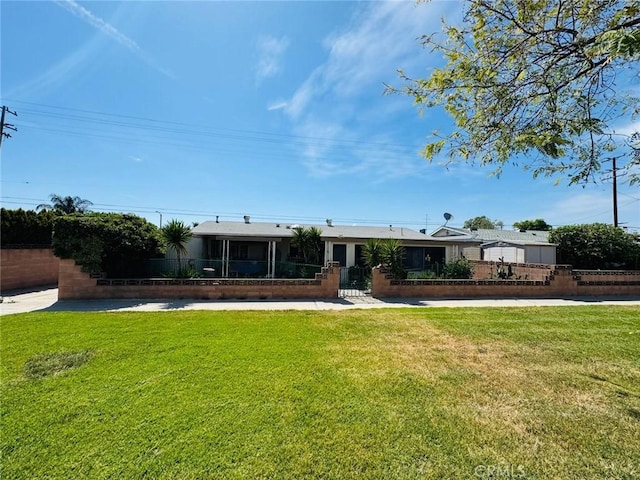 view of front of house featuring a fenced front yard, a front lawn, and a gate
