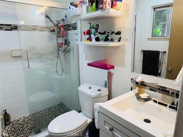 full bathroom featuring vanity, toilet, and a shower stall
