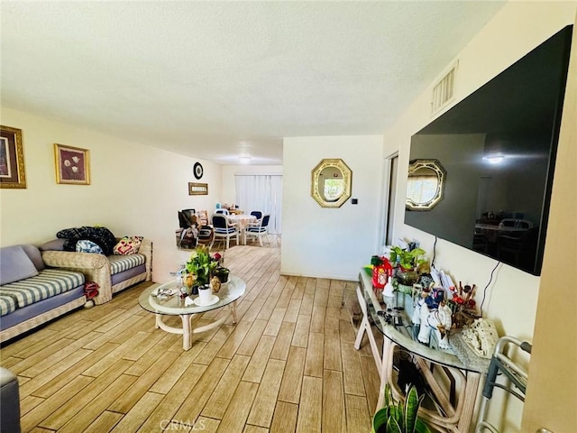 living room with visible vents and wood finished floors