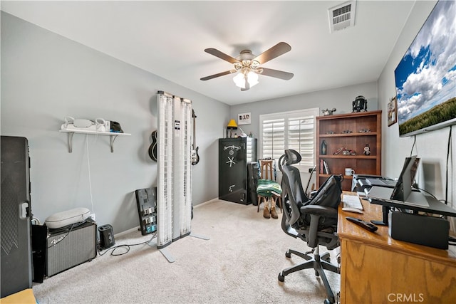 home office with a ceiling fan, baseboards, visible vents, and carpet floors