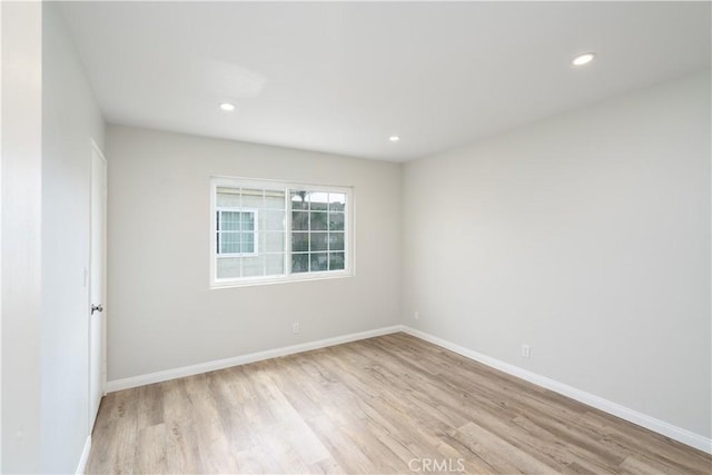 unfurnished room featuring recessed lighting, baseboards, and wood finished floors
