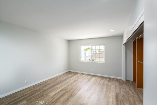 unfurnished bedroom featuring light wood-style flooring, baseboards, and recessed lighting