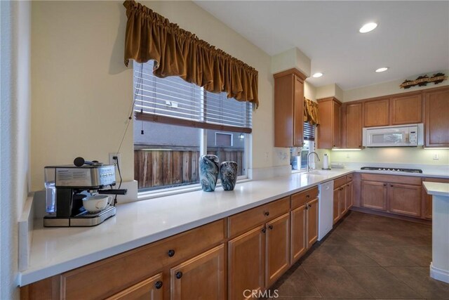 38493 Falkirk Dr, Murrieta, CA 92563 - kitchen with white appliances, light countertops, dark tile patterned floors, brown cabinetry, and recessed lighting
