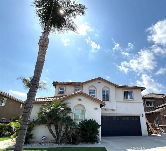 38493 Falkirk Dr, Murrieta, CA 92563 - mediterranean / spanish-style home with an attached garage, stucco siding, driveway, and a tile roof