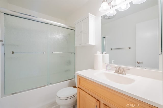 full bathroom featuring vanity, toilet, bath / shower combo with glass door, and an inviting chandelier