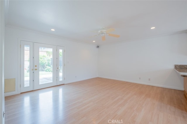 unfurnished room with light wood finished floors, a ceiling fan, and ornamental molding