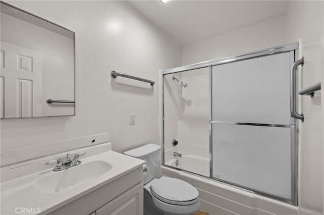 full bathroom with vanity, toilet, and bath / shower combo with glass door