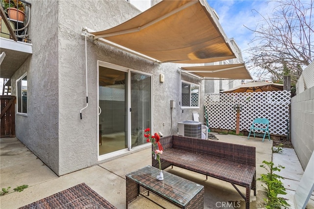 view of patio with fence and central AC