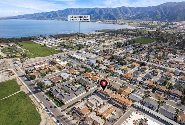 drone / aerial view featuring a water and mountain view