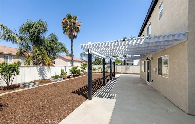 view of patio / terrace with a fenced backyard, a pergola, and a garden