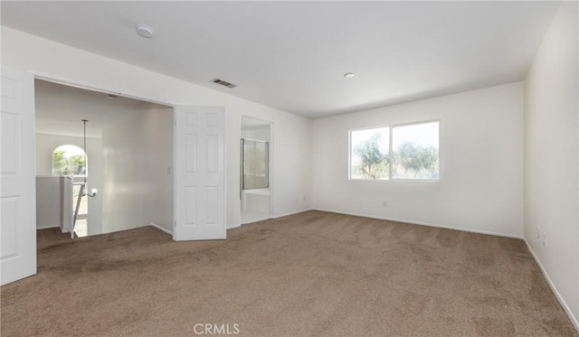 unfurnished room featuring carpet flooring, baseboards, plenty of natural light, and visible vents