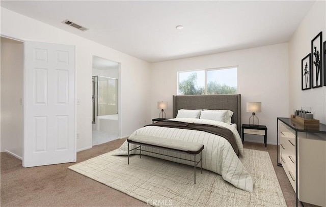bedroom featuring connected bathroom, carpet floors, and visible vents