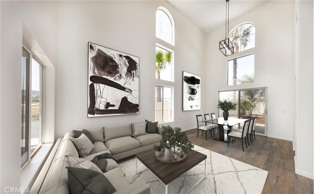 living area featuring a wealth of natural light and a high ceiling