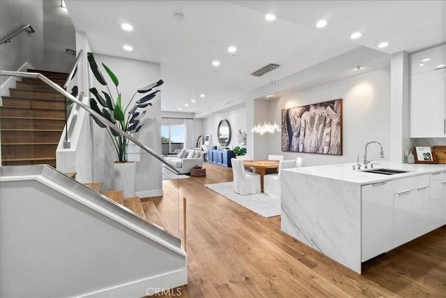22065 Pacific Coast Hwy Unit 3, Malibu, CA 90265 - kitchen featuring a sink, recessed lighting, light wood finished floors, white cabinets, and modern cabinets