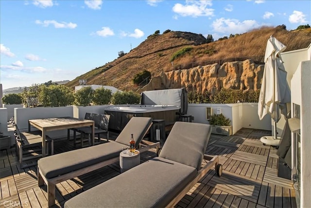22065 Pacific Coast Hwy Unit 3, Malibu, CA 90265 - wooden deck with outdoor dining space, a hot tub, a mountain view, and outdoor lounge area