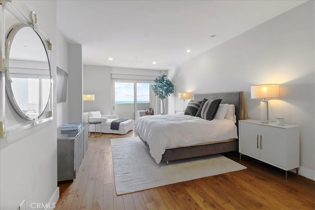 22065 Pacific Coast Hwy Unit 3, Malibu, CA 90265 - bedroom featuring hardwood / wood-style flooring, baseboards, recessed lighting, and access to exterior