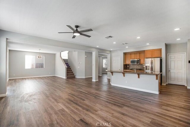 13167 Hollister St, Hesperia, CA 92344 - unfurnished living room featuring a sink, dark wood finished floors, stairway, baseboards, and a ceiling fan