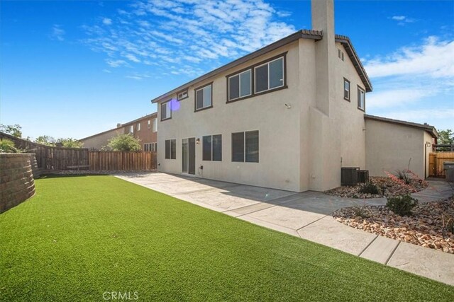 13167 Hollister St, Hesperia, CA 92344 - rear view of property with stucco siding, a patio area, central AC unit, and a chimney