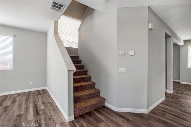 13167 Hollister St, Hesperia, CA 92344 - staircase featuring wood finished floors, plenty of natural light, and baseboards