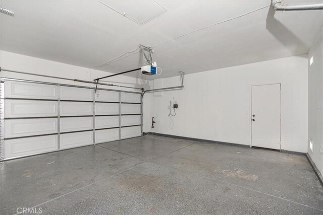 13167 Hollister St, Hesperia, CA 92344 - garage featuring a garage door opener and baseboards
