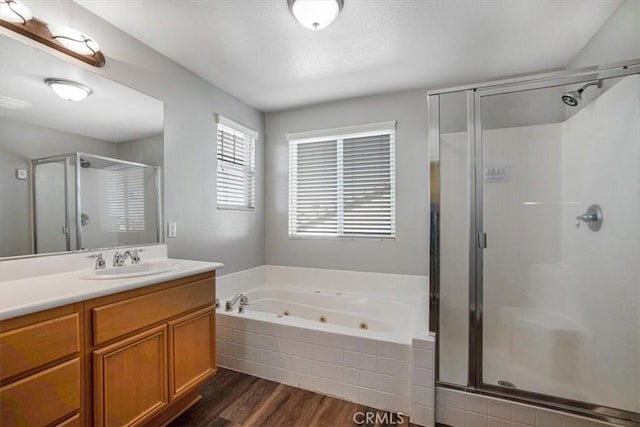 13167 Hollister St, Hesperia, CA 92344 - bathroom with a stall shower, vanity, a whirlpool tub, and wood finished floors