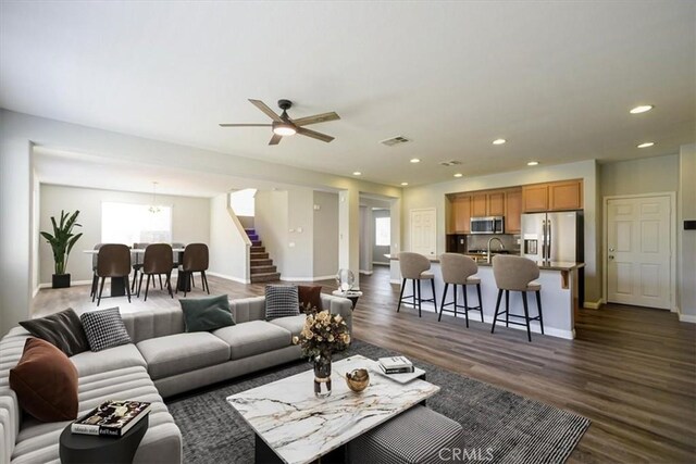 13167 Hollister St, Hesperia, CA 92344 - living area featuring stairs, healthy amount of natural light, dark wood-style flooring, and recessed lighting