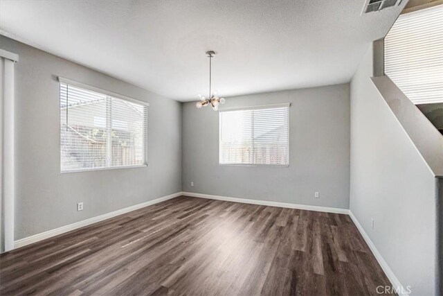 13167 Hollister St, Hesperia, CA 92344 - spare room featuring wood finished floors, a chandelier, and baseboards