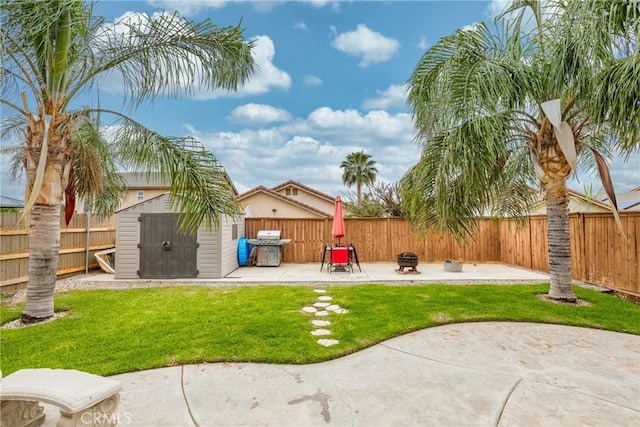 view of yard with an outbuilding, a patio, a shed, and a fenced backyard