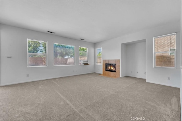43629 Rucker Ct, Lancaster, CA 93535 - unfurnished living room featuring light colored carpet, plenty of natural light, baseboards, and a fireplace