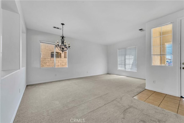 43629 Rucker Ct, Lancaster, CA 93535 - tiled empty room featuring carpet flooring, a notable chandelier, baseboards, and visible vents